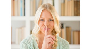 Person making a shushing gesture.