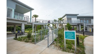 A wheelchair ramp leading to a lodge and restaurant.